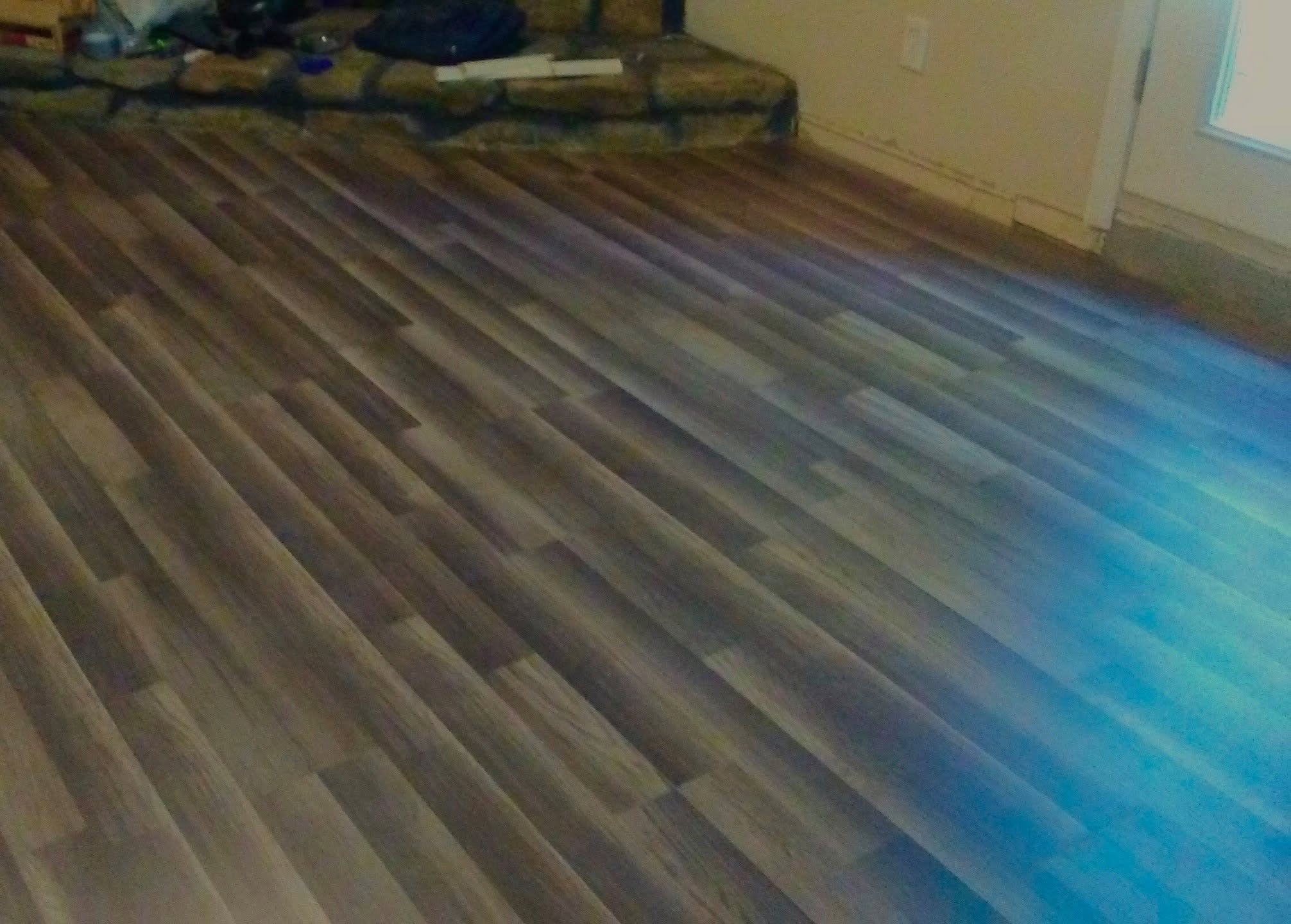 Newly installed wood-look plank flooring in a living room