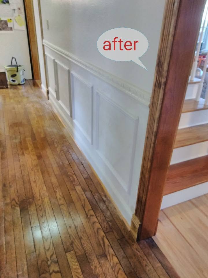 Finished white hallway wainscoting beside wood flooring, labeled after